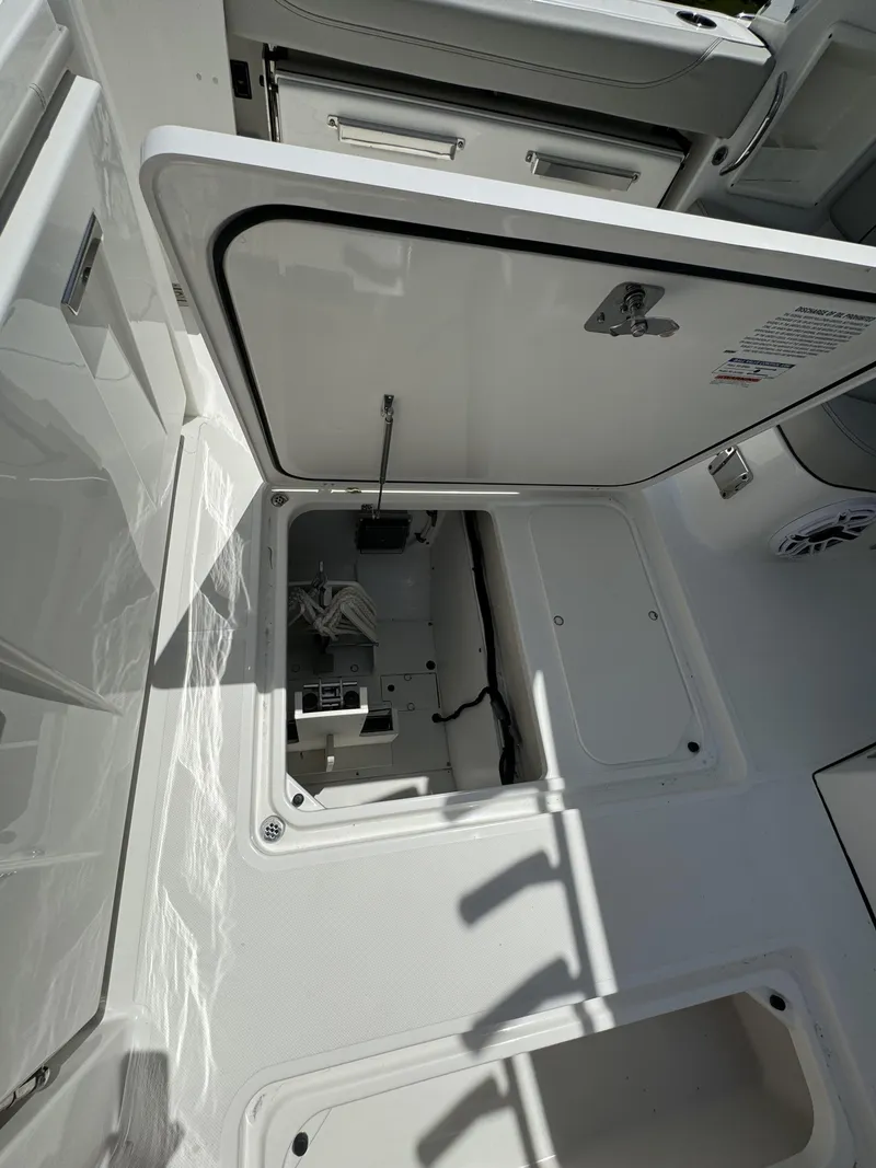 Slide: The Image of 2025 Pursuit DC 326 boat with dual engines and open storage compartment. - 8
