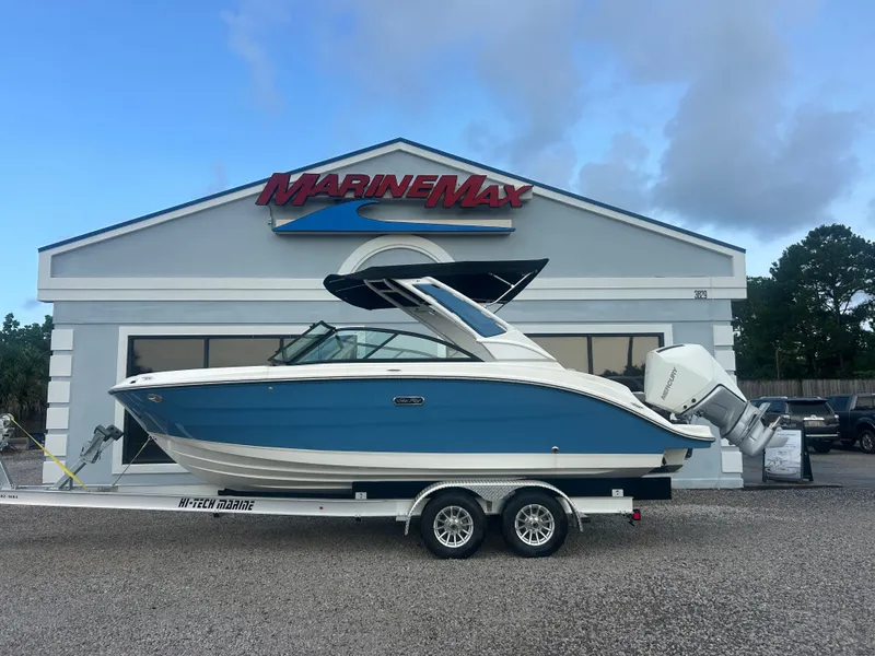 Slide: The Image of A 2026 Sea Ray SDX 230 Outboard on a trailer in front of a MarineMax building. - 0