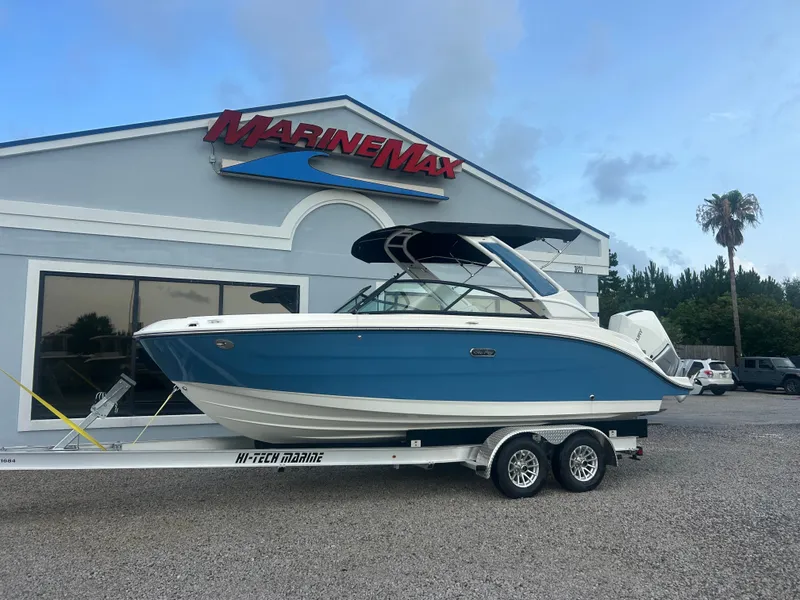 Slide: The Image of Sea Ray SDX 230 Outboard 2026 on a trailer in front of a building. - 2