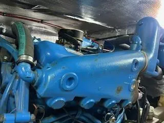 Slide: The Image of Close-up of a 1967 Chris-Craft 38 Commander engine, showcasing blue components and hoses. - 28