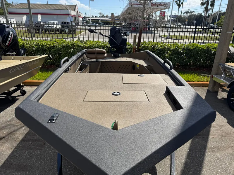 Slide: The Image of 2025 Excel Eclipse boat, tan deck, parked outdoors, sunny day. - 12