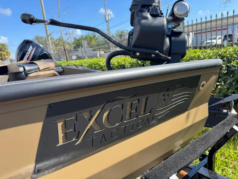 Slide: The Image of 2025 Excel Eclipse boat with tactical branding, parked outdoors on a sunny day. - 2