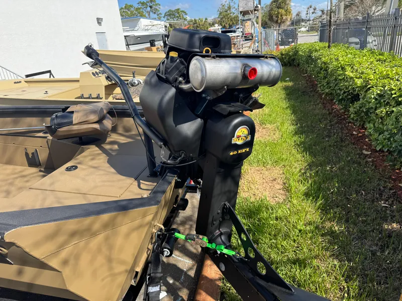 Slide: The Image of Boat with Excel Eclipse 2025 motor, parked on grass beside a hedge. - 3