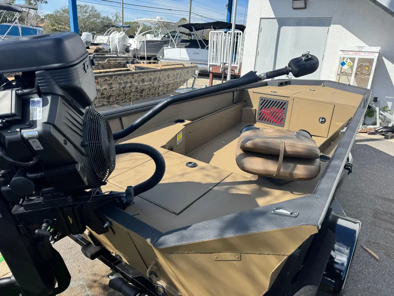 Slide: The Image of 2025 Excel Eclipse boat with motor, tan interior, and outdoor setting. - 6