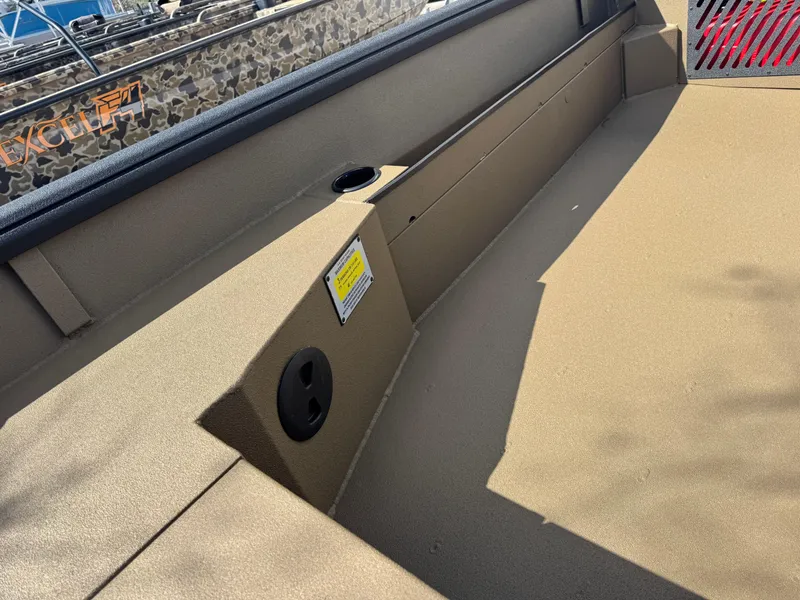 Slide: The Image of 2025 Excel Eclipse boat interior with tan finish and storage compartments. - 8