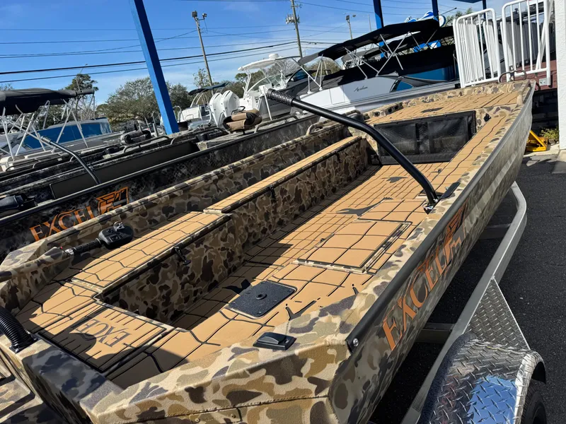 Slide: The Image of 2025 Excel 1860 F4 Shallow Water boat with camouflage design on display at a dealership. - 20