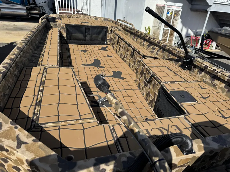 Slide: The Image of 2025 Excel 1860 F4 Shallow Water boat with camouflage design and spacious interior. - 25