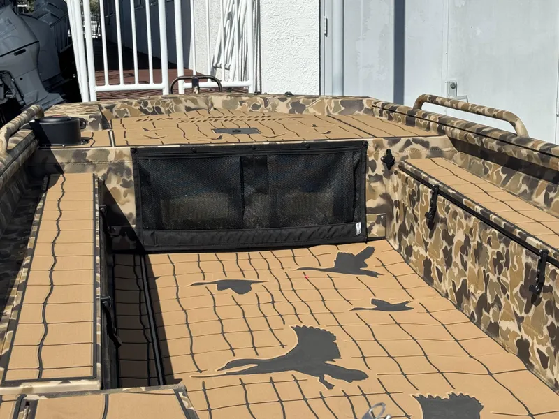 Slide: The Image of 2025 Excel 1860 F4 Shallow Water boat with camouflage design and bird graphics. - 26