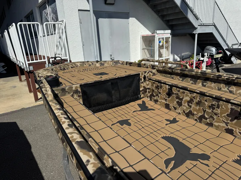 Slide: The Image of 2025 Excel 1860 F4 Shallow Water boat with camouflage design and bird patterns. - 27