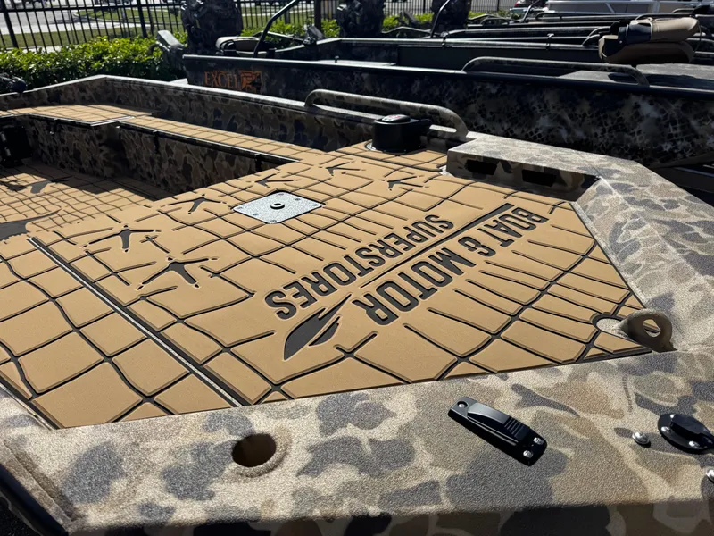 Slide: The Image of 2025 Excel 1860 F4 Shallow Water boat with camo design and "Boat & Motor Superstores" branding. - 3