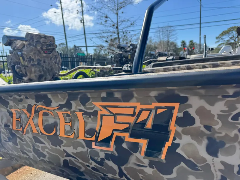 Slide: The Image of 2025 Excel 1860 F4 Shallow Water boat with camouflage design in outdoor setting. - 6