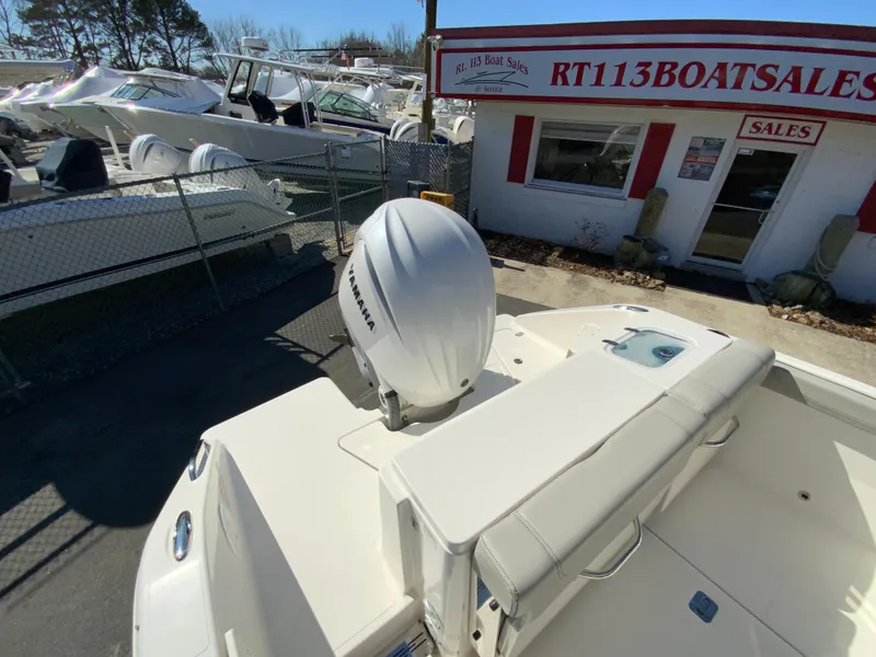 Slide: The Image of 2024 Pursuit DC 246 Dual Console boat at dealership, featuring Yamaha outboard motor. - 12