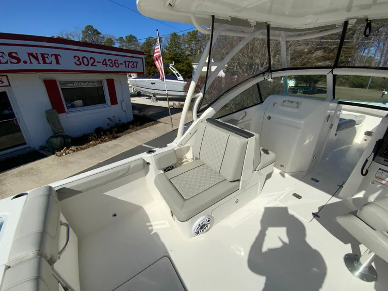 Slide: The Image of 2024 Pursuit DC 246 Dual Console boat interior with seating and helm station. - 13