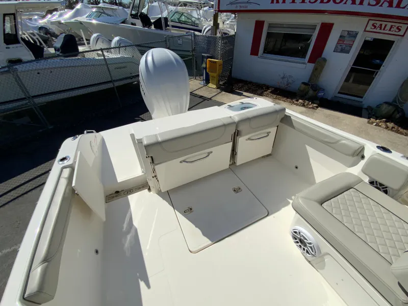 Slide: The Image of 2024 Pursuit DC 246 Dual Console boat interior with seating and storage. - 15