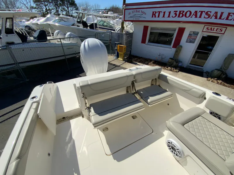 Slide: The Image of 2024 Pursuit DC 246 Dual Console boat at dealership, featuring spacious seating and modern design. - 16