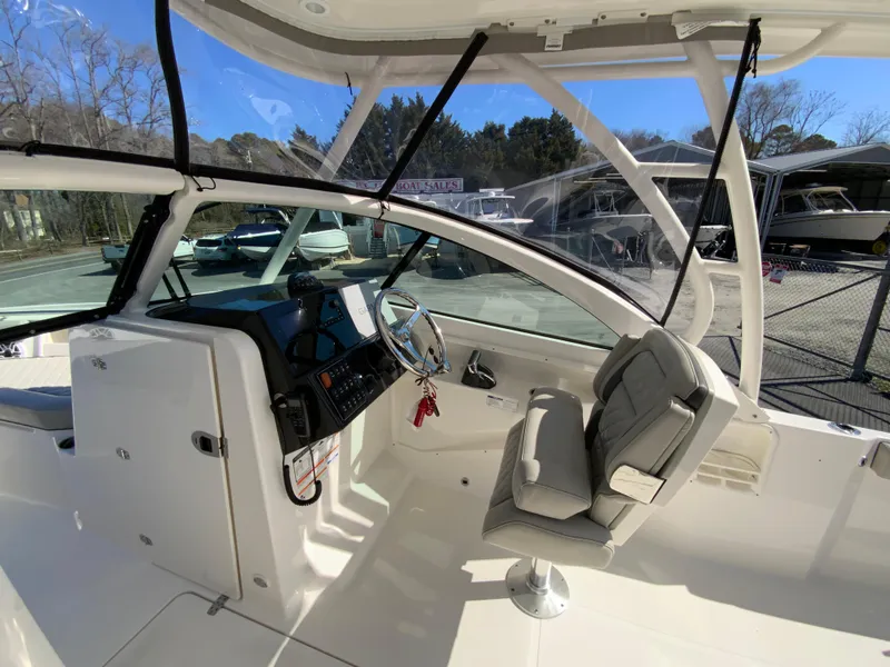 Slide: The Image of 2024 Pursuit DC 246 Dual Console boat interior with helm and seating. - 20