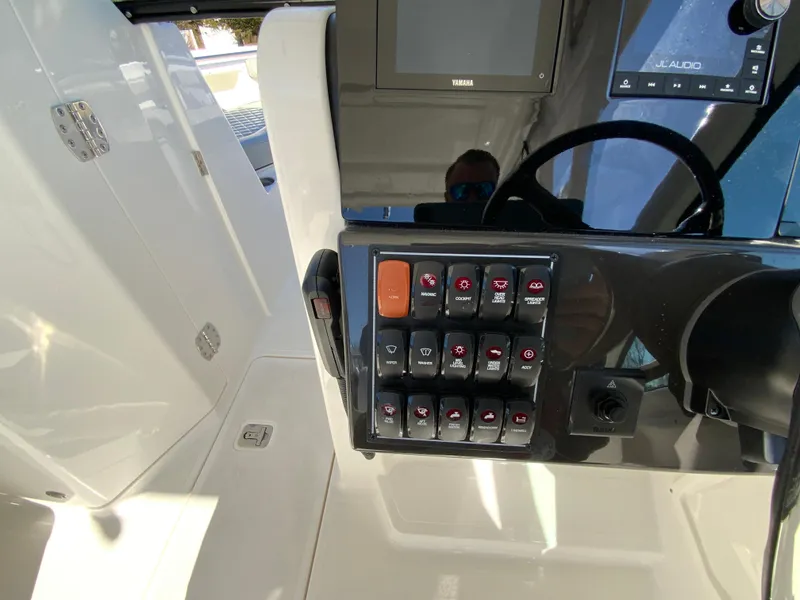 Slide: The Image of 2024 Pursuit DC 246 Dual Console dashboard with control panel and steering wheel. - 25