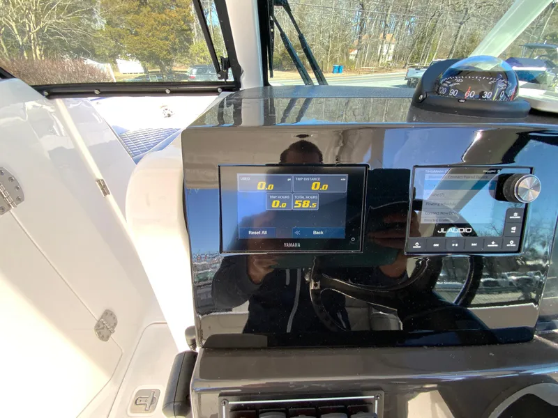 Slide: The Image of 2024 Pursuit DC 246 Dual Console dashboard with digital display and controls. - 26