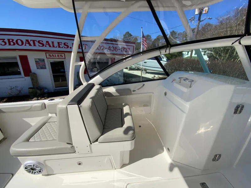 Slide: The Image of 2024 Pursuit DC 246 Dual Console boat interior with seating, near a sales office. - 27