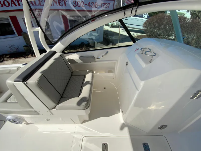 Slide: The Image of 2024 Pursuit DC 246 Dual Console boat interior with seating and dashboard. - 29