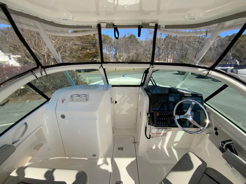Slide: The Image of 2024 Pursuit DC 246 Dual Console boat interior with steering wheel and dashboard. - 36