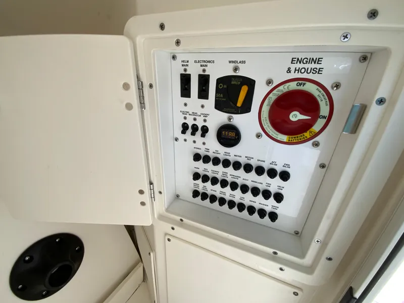 Slide: The Image of 2024 Pursuit DC 246 Dual Console control panel with engine and house switches. - 39