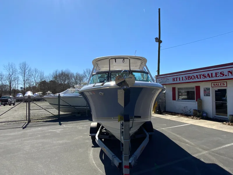 Slide: The Image of 2024 Pursuit DC 246 Dual Console boat on trailer at dealership. - 4