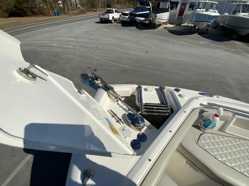 Slide: The Image of 2024 Pursuit DC 246 Dual Console boat interior with open storage compartment. - 47