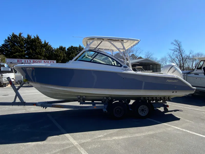 Slide: The Image of 2024 Pursuit DC 246 Dual Console boat on trailer in parking lot. - 6