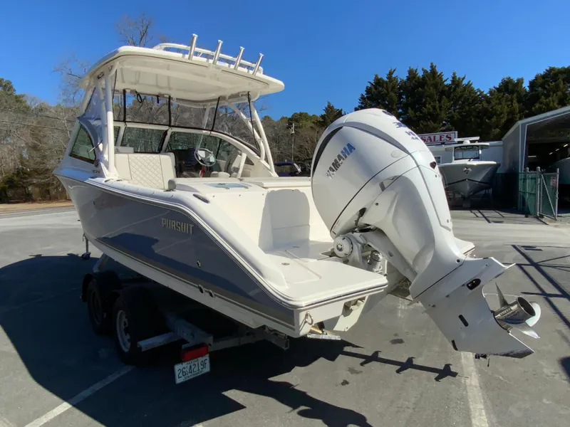Slide: The Image of 2024 Pursuit DC 246 Dual Console boat with Yamaha outboard engine on a trailer. - 8