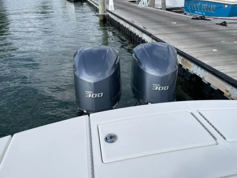 Slide: The Image of Twin Yamaha 300 engines on a 2021 Regulator 28 boat at a dock. - 1