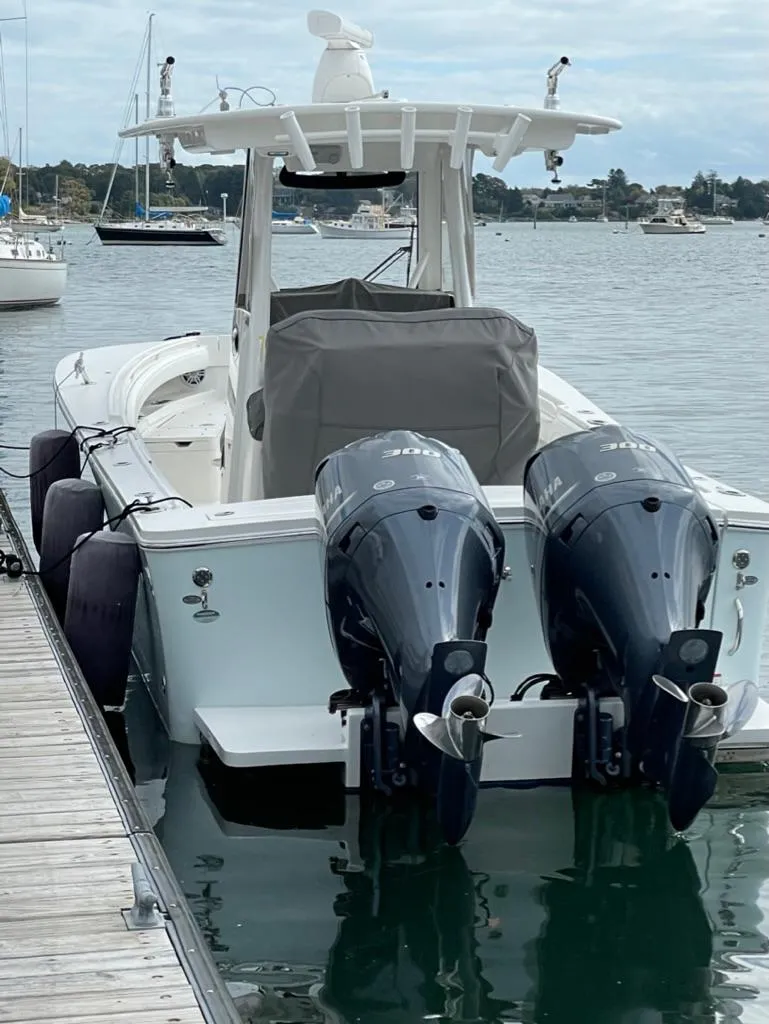 Slide: The Image of 2021 Regulator 28 boat with twin outboard engines docked in a marina. - 7