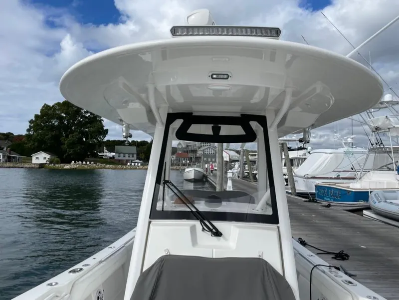 Slide: The Image of 2021 Regulator 28 boat docked, featuring a sleek design and spacious deck. - 8