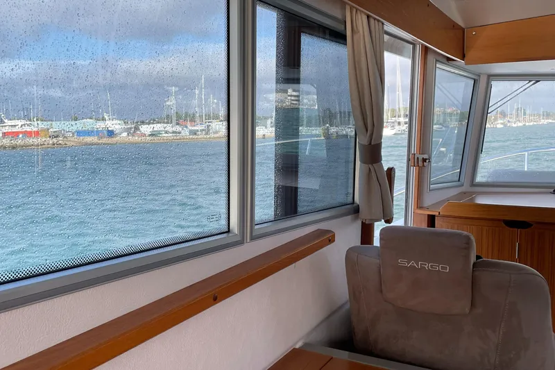 Slide: The Image of Interior view of 2015 Sargo 36 Flybridge yacht with marina in the background. - 12