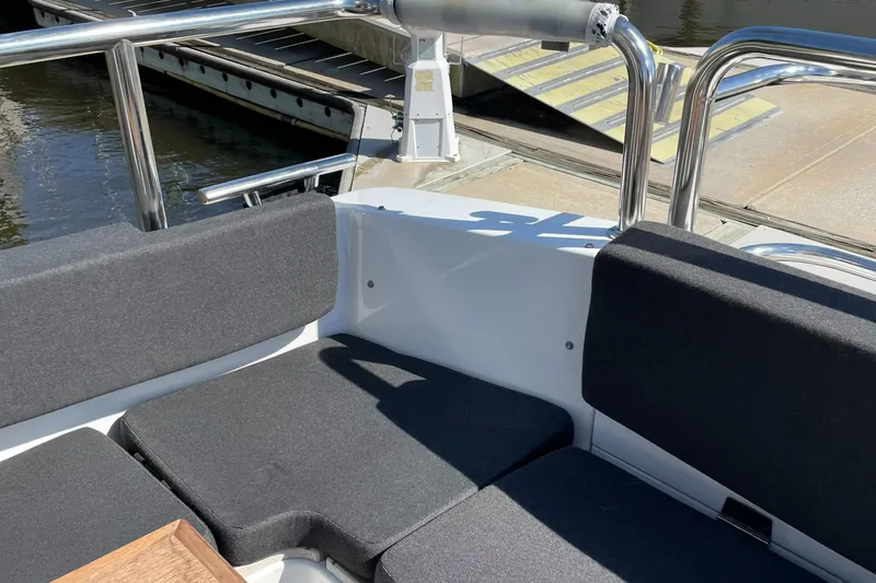 Slide: The Image of Sargo 36 Flybridge 2015 boat seating area with gray cushions and metal railings. - 14