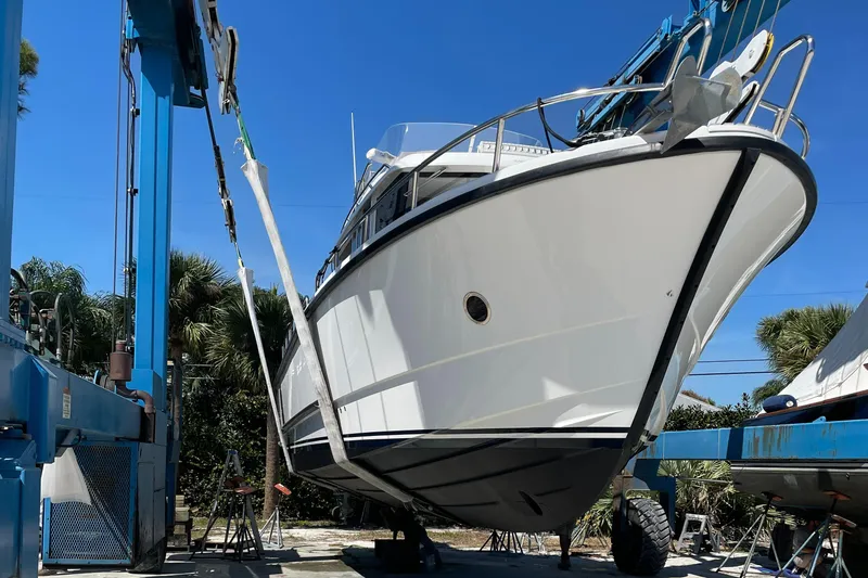 Slide: The Image of Sargo 36 Flybridge 2015 boat being lifted by a crane under clear blue sky. - 5