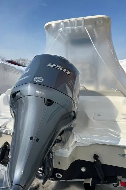 Slide: The Image of 2023 Key West 239 FS boat with a 250 horsepower engine, wrapped in protective covering. - 13