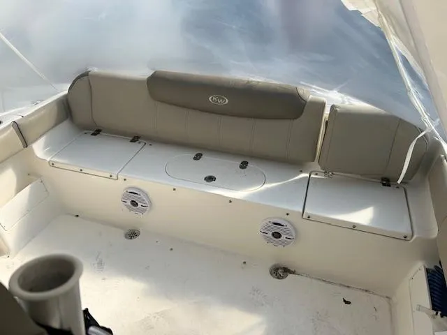Slide: The Image of 2023 Key West 239 FS boat interior with cushioned seating and built-in speakers. - 6