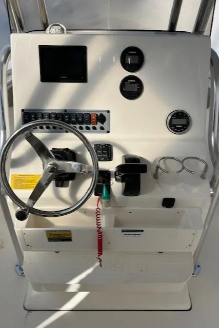 Slide: The Image of 2023 Key West 239 FS boat dashboard with steering wheel and controls. - 7