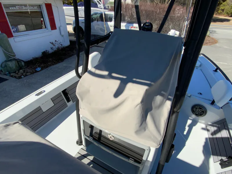 Slide: The Image of 2023 Pathfinder 2200 TRS boat interior with covered console and seating area. - 11