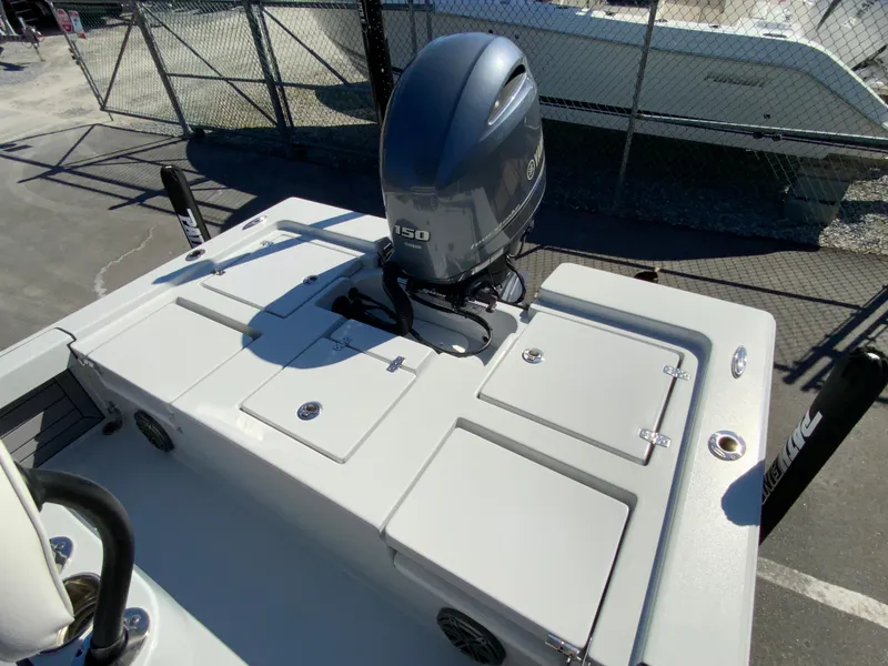 Slide: The Image of 2023 Pathfinder 2200 TRS boat with powerful outboard motor, docked in a marina. - 12