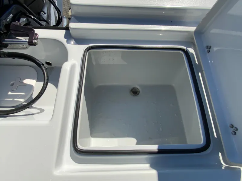 Slide: The Image of Livewell compartment on 2023 Pathfinder 2200 TRS boat, open and empty. - 15