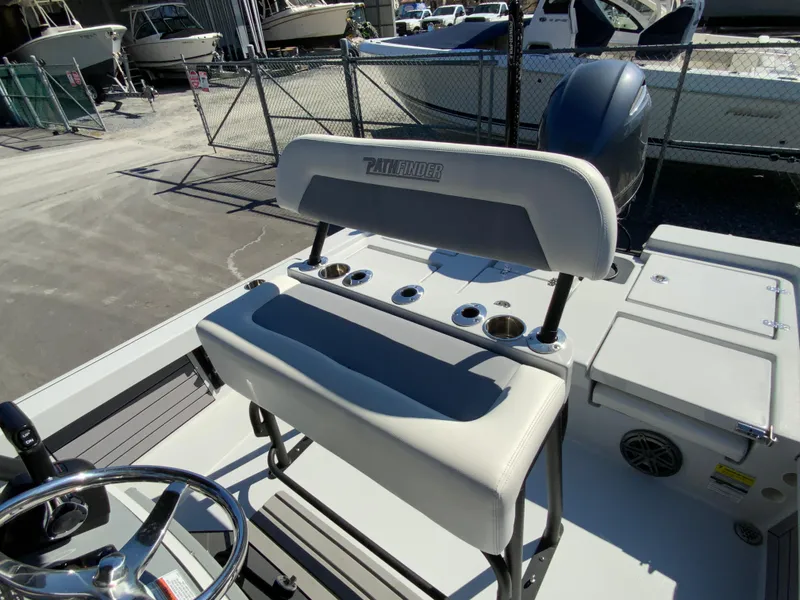 Slide: The Image of 2023 Pathfinder 2200 TRS boat interior with seating and steering wheel. - 18