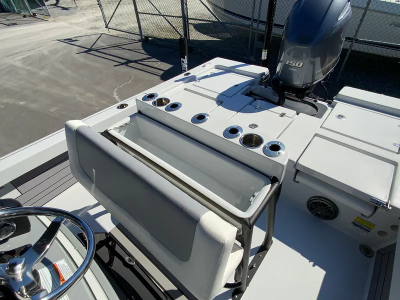 Slide: The Image of 2023 Pathfinder 2200 TRS boat interior with seating and engine view. - 20