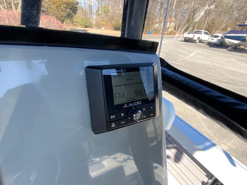 Slide: The Image of 2023 Pathfinder 2200 TRS boat dashboard with JL Audio system display. - 24