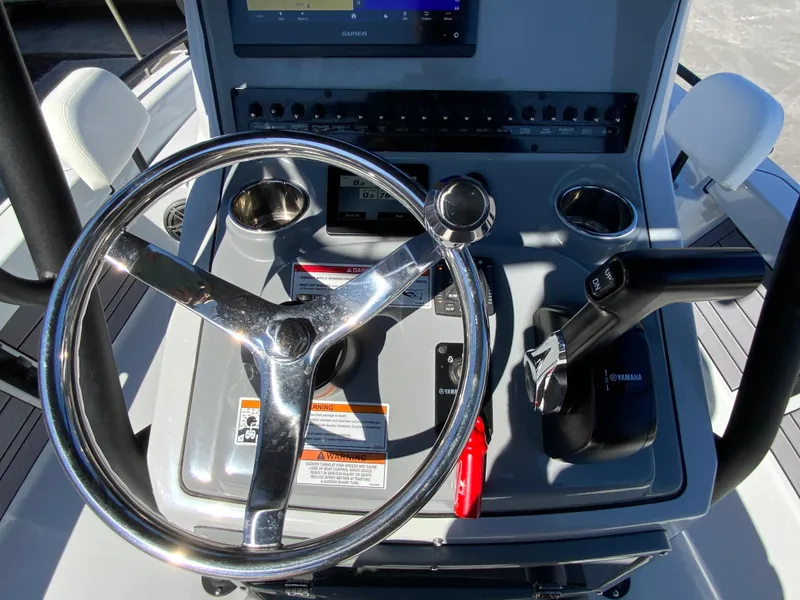 Slide: The Image of 2023 Pathfinder 2200 TRS boat console with steering wheel and controls. - 26