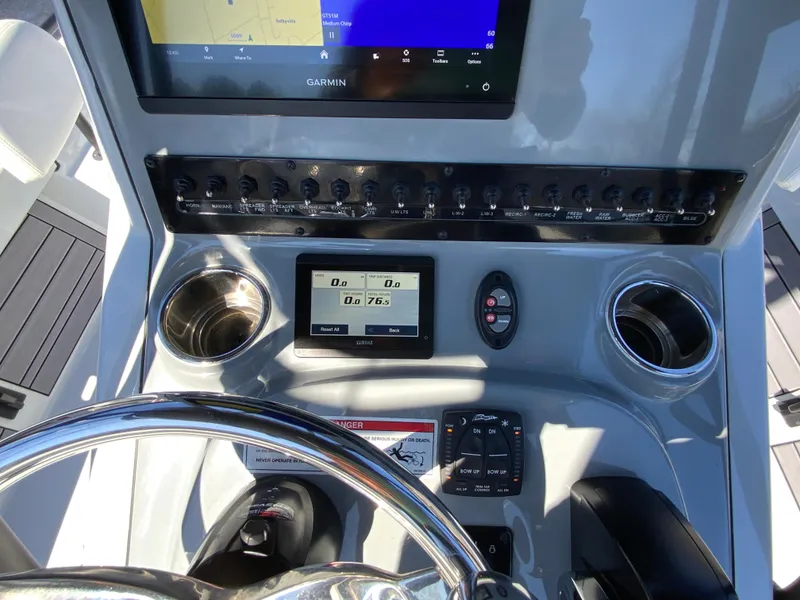 Slide: The Image of 2023 Pathfinder 2200 TRS boat dashboard with Garmin display and controls. - 27