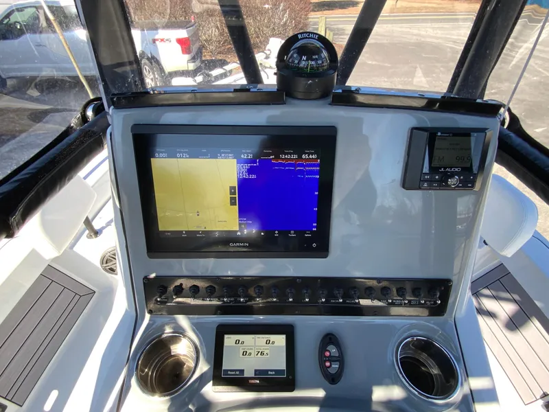 Slide: The Image of 2023 Pathfinder 2200 TRS boat dashboard with navigation and control systems. - 28