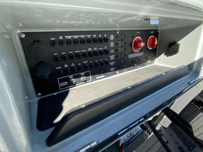 Slide: The Image of 2023 Pathfinder 2200 TRS boat control panel with switches and dials. - 29