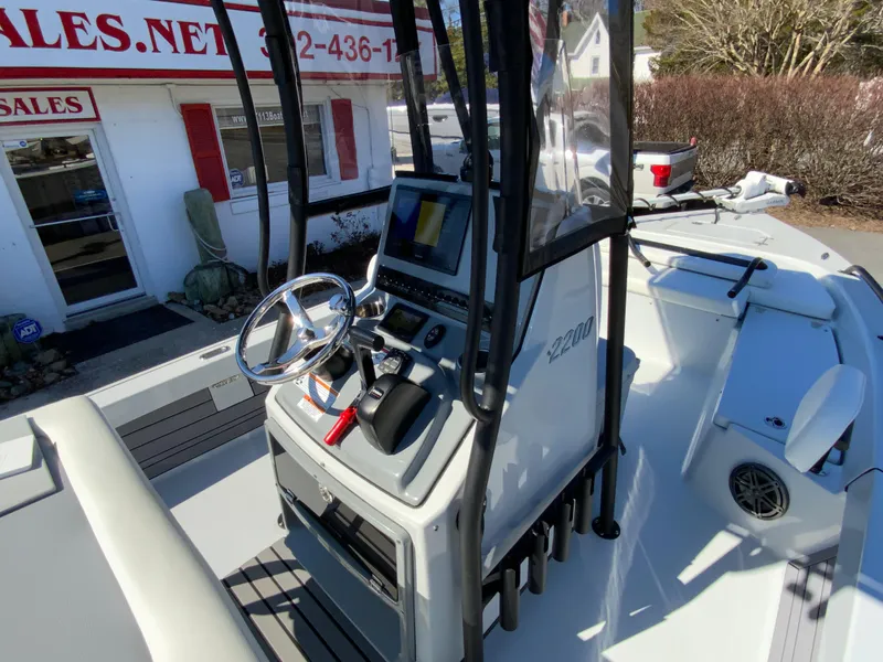 Slide: The Image of 2023 Pathfinder 2200 TRS boat console with steering wheel and navigation equipment. - 31